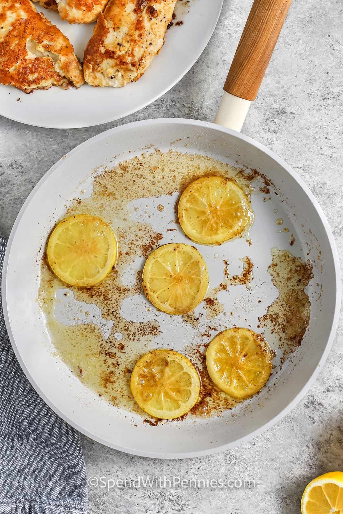 cooked lemon slices in a pan to make Chicken Francese