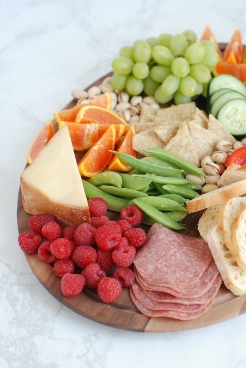 A charcuterie board sits on a white countertop