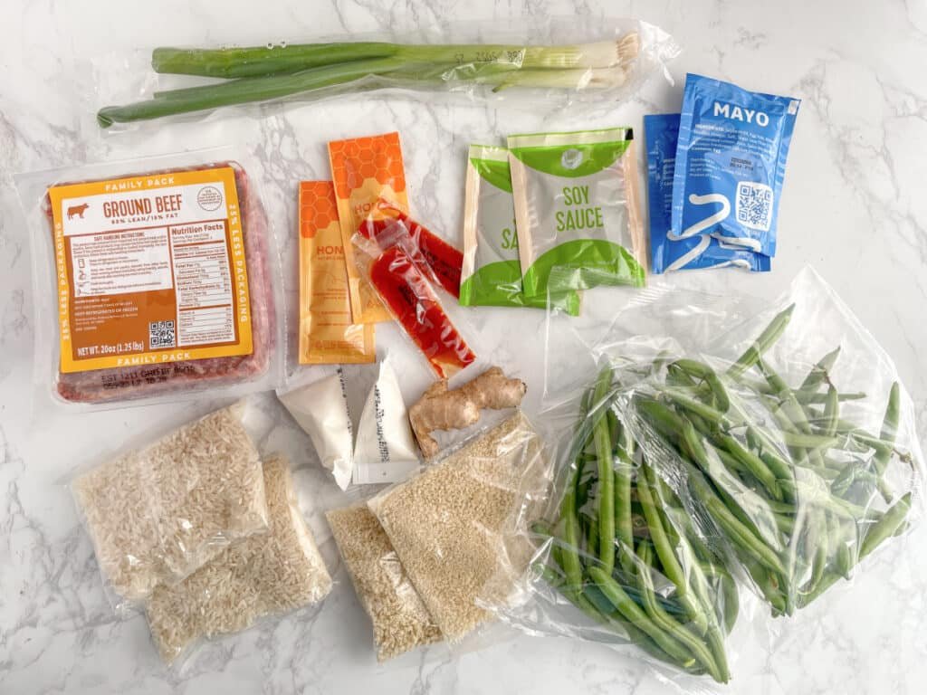 Ingredients for a HelloFresh meal sit on a white countertop