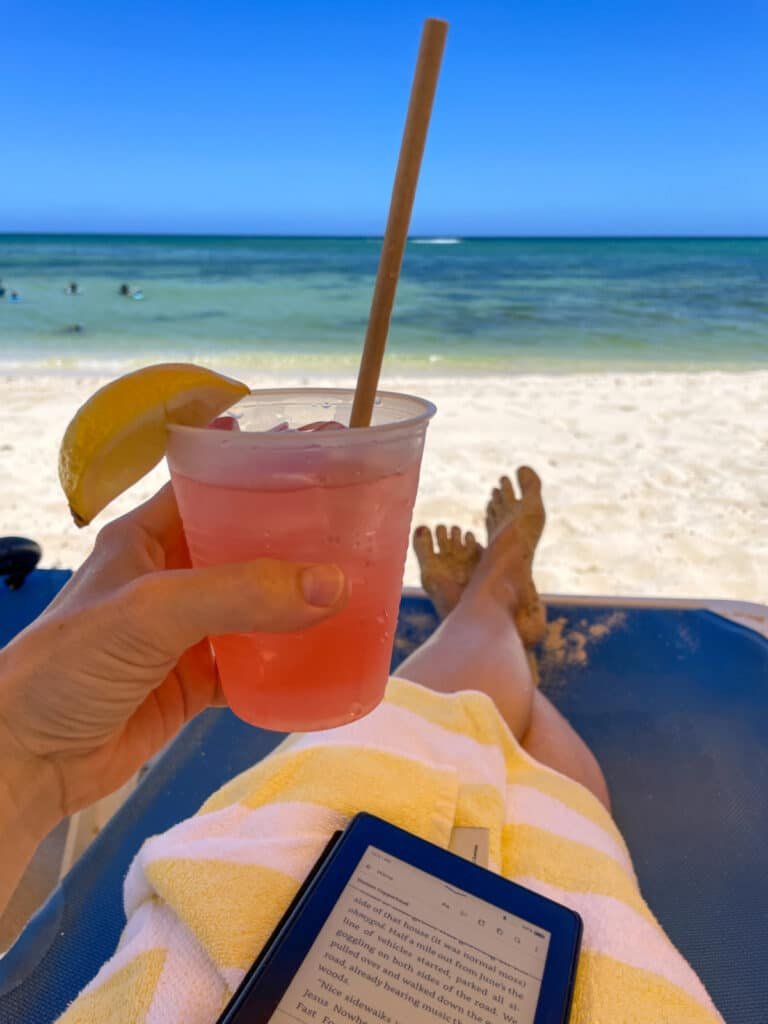 Woman on chaise lounge holding a pink drink in Grand Cayman