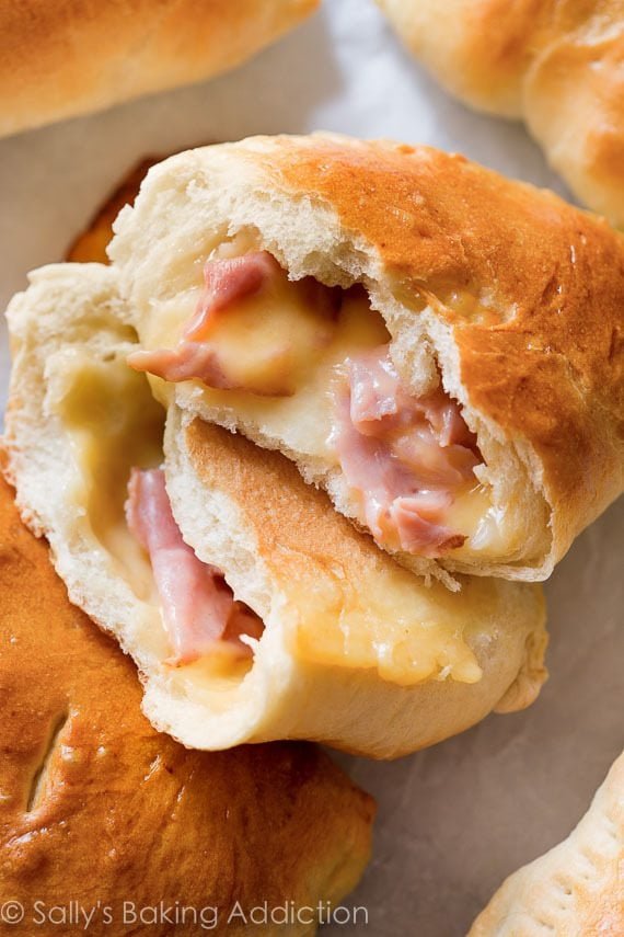 ham and cheese pockets with one pocket cut in half showing ham and cheese filling