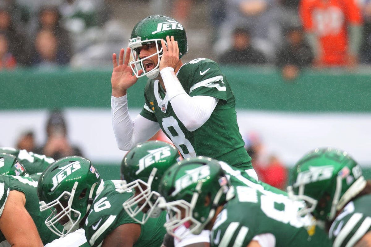 Aaron Rodgers of the New York Jets calls out against the Denver Broncos during the first half at MetLife Stadium