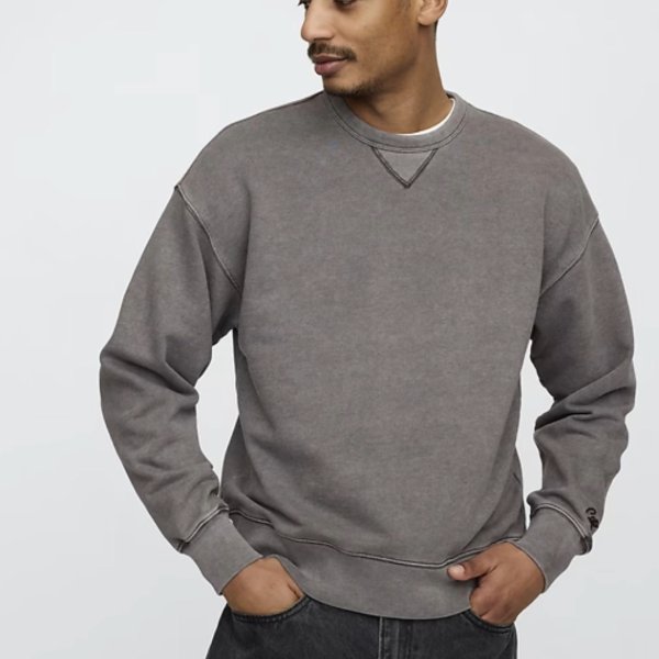 a man wearing a crewneck sweater