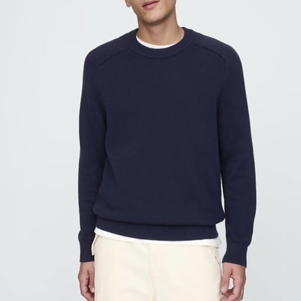 a man wearing a raglan style crewneck sweater